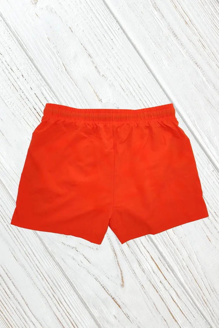 Maskulo Jedd Synther Soft Shorts in orange. Nylon-polyester shorts with 2 side zip-pockets, soft white mesh lining, and 3D PVC label.
