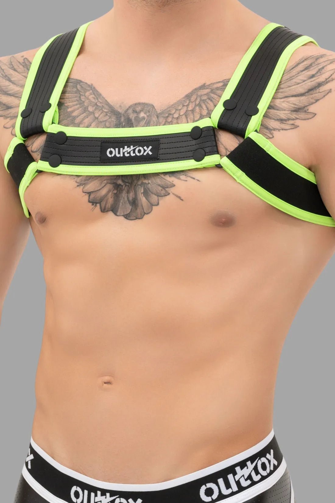 Outtox Bulldog Harness in Black/Neon Green. Features PU leather straps, snaps, and adjustable buckles for a bold, comfortable fetish look.